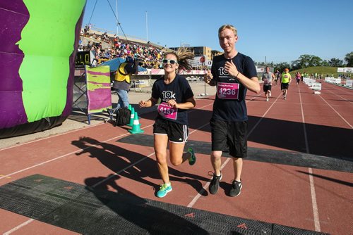 Participants in the Manitoba Marathon approach the finish line inside the University of Manitoba stadium Sunday morning. 150621 - Sunday, June 21, 2015 -  MIKE DEAL / WINNIPEG FREE PRESS