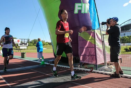 Participants in the Manitoba Marathon approach the finish line inside the University of Manitoba stadium Sunday morning. 150621 - Sunday, June 21, 2015 -  MIKE DEAL / WINNIPEG FREE PRESS