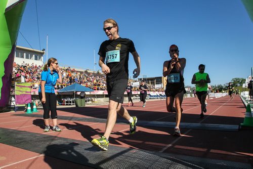 Participants in the Manitoba Marathon approach the finish line inside the University of Manitoba stadium Sunday morning. 150621 - Sunday, June 21, 2015 -  MIKE DEAL / WINNIPEG FREE PRESS