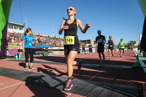 Participants in the Manitoba Marathon approach the finish line inside the University of Manitoba stadium Sunday morning. 150621 - Sunday, June 21, 2015 -  MIKE DEAL / WINNIPEG FREE PRESS