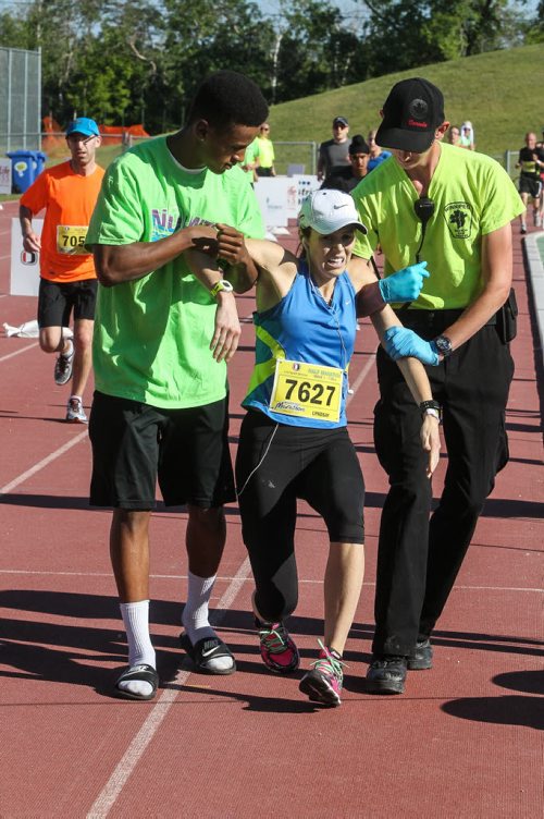 Participants in the Manitoba Marathon approach the finish line inside the University of Manitoba stadium Sunday morning. 150621 - Sunday, June 21, 2015 -  MIKE DEAL / WINNIPEG FREE PRESS