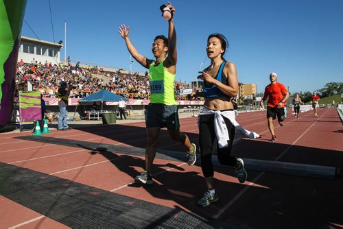 Participants in the Manitoba Marathon approach the finish line inside the University of Manitoba stadium Sunday morning. 150621 - Sunday, June 21, 2015 -  MIKE DEAL / WINNIPEG FREE PRESS