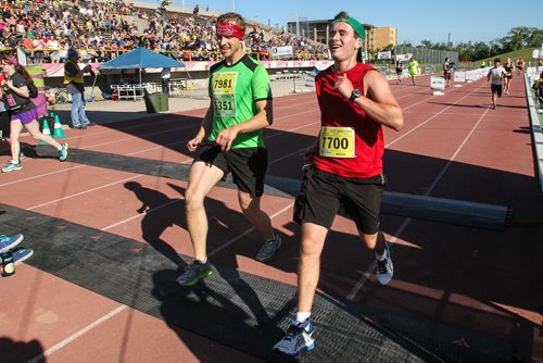 Participants in the Manitoba Marathon approach the finish line inside the University of Manitoba stadium Sunday morning. 150621 - Sunday, June 21, 2015 -  MIKE DEAL / WINNIPEG FREE PRESS