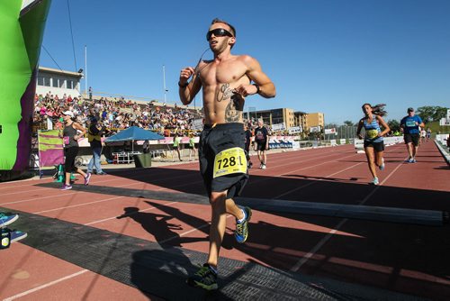 Participants in the Manitoba Marathon approach the finish line inside the University of Manitoba stadium Sunday morning. 150621 - Sunday, June 21, 2015 -  MIKE DEAL / WINNIPEG FREE PRESS