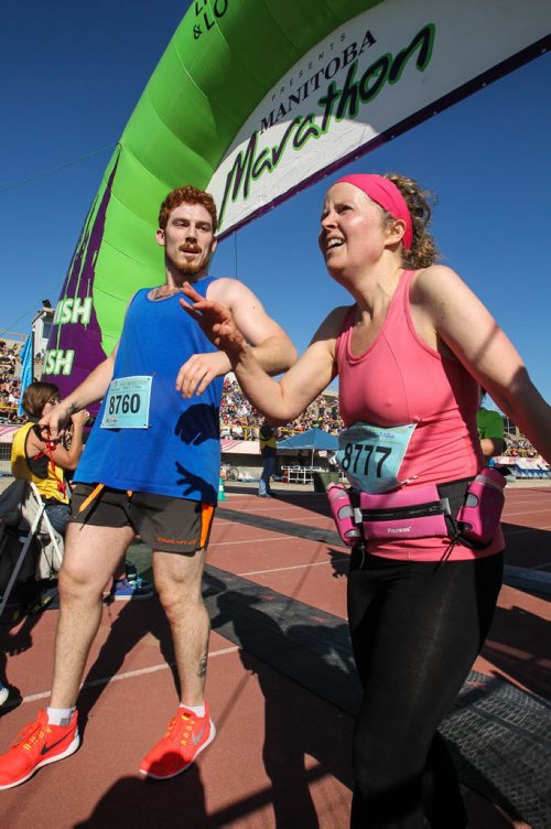 Participants in the Manitoba Marathon approach the finish line inside the University of Manitoba stadium Sunday morning. 150621 - Sunday, June 21, 2015 -  MIKE DEAL / WINNIPEG FREE PRESS