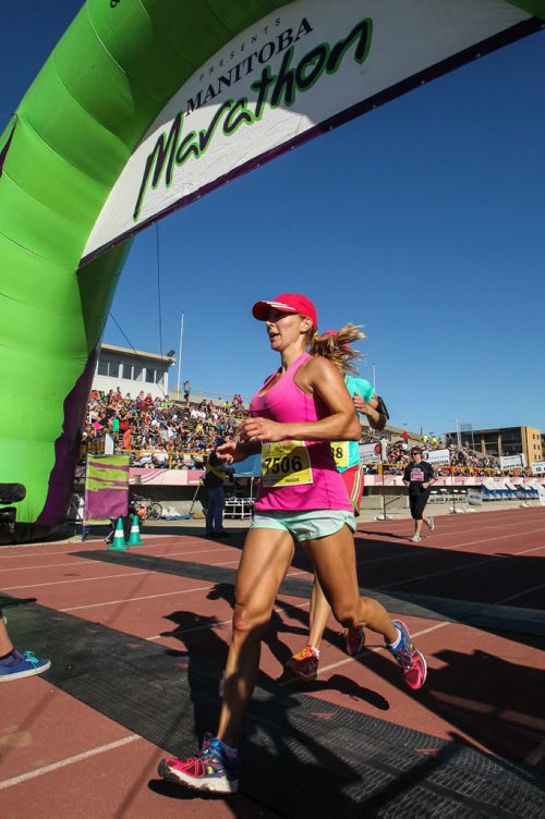 Participants in the Manitoba Marathon approach the finish line inside the University of Manitoba stadium Sunday morning. 150621 - Sunday, June 21, 2015 -  MIKE DEAL / WINNIPEG FREE PRESS