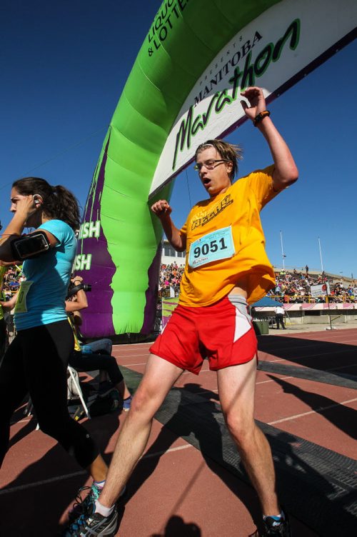 Participants in the Manitoba Marathon approach the finish line inside the University of Manitoba stadium Sunday morning. 150621 - Sunday, June 21, 2015 -  MIKE DEAL / WINNIPEG FREE PRESS