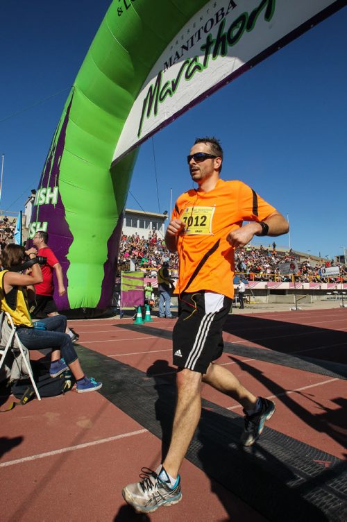 Participants in the Manitoba Marathon approach the finish line inside the University of Manitoba stadium Sunday morning. 150621 - Sunday, June 21, 2015 -  MIKE DEAL / WINNIPEG FREE PRESS