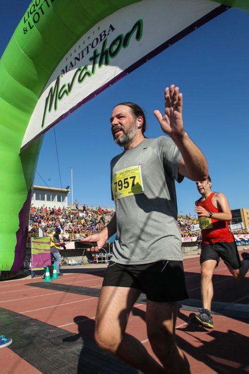 Participants in the Manitoba Marathon approach the finish line inside the University of Manitoba stadium Sunday morning. 150621 - Sunday, June 21, 2015 -  MIKE DEAL / WINNIPEG FREE PRESS