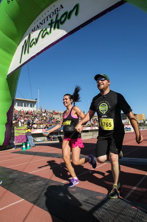 Participants in the Manitoba Marathon approach the finish line inside the University of Manitoba stadium Sunday morning. 150621 - Sunday, June 21, 2015 -  MIKE DEAL / WINNIPEG FREE PRESS