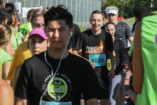 Participants in the Manitoba Marathon approach the finish line inside the University of Manitoba stadium Sunday morning. 150621 - Sunday, June 21, 2015 -  MIKE DEAL / WINNIPEG FREE PRESS