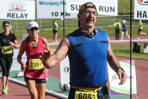 Participants in the Manitoba Marathon approach the finish line inside the University of Manitoba stadium Sunday morning. 150621 - Sunday, June 21, 2015 -  MIKE DEAL / WINNIPEG FREE PRESS