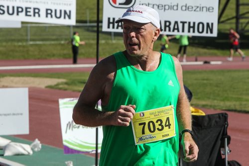 Participants in the Manitoba Marathon approach the finish line inside the University of Manitoba stadium Sunday morning. 150621 - Sunday, June 21, 2015 -  MIKE DEAL / WINNIPEG FREE PRESS