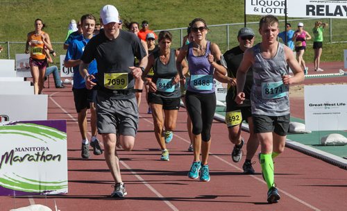 Participants in the Manitoba Marathon approach the finish line inside the University of Manitoba stadium Sunday morning. 150621 - Sunday, June 21, 2015 -  MIKE DEAL / WINNIPEG FREE PRESS