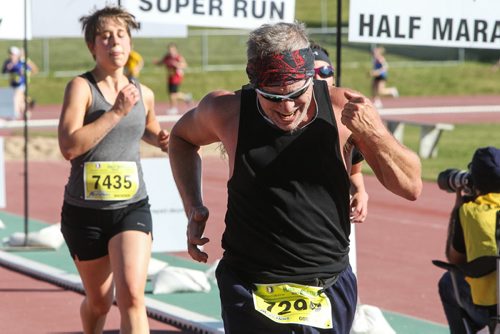 Participants in the Manitoba Marathon approach the finish line inside the University of Manitoba stadium Sunday morning. 150621 - Sunday, June 21, 2015 -  MIKE DEAL / WINNIPEG FREE PRESS