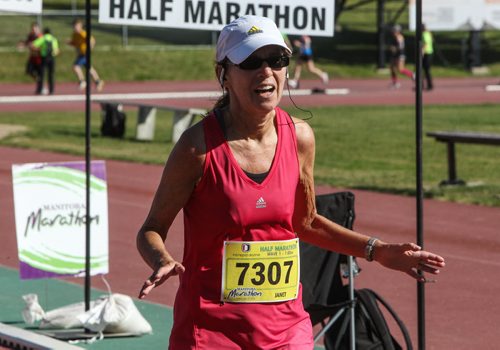 Participants in the Manitoba Marathon approach the finish line inside the University of Manitoba stadium Sunday morning. 150621 - Sunday, June 21, 2015 -  MIKE DEAL / WINNIPEG FREE PRESS