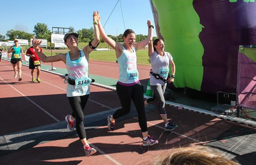 Participants in the Manitoba Marathon approach the finish line inside the University of Manitoba stadium Sunday morning. 150621 - Sunday, June 21, 2015 -  MIKE DEAL / WINNIPEG FREE PRESS