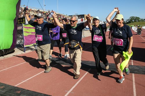 Participants in the Manitoba Marathon approach the finish line inside the University of Manitoba stadium Sunday morning. 150621 - Sunday, June 21, 2015 -  MIKE DEAL / WINNIPEG FREE PRESS