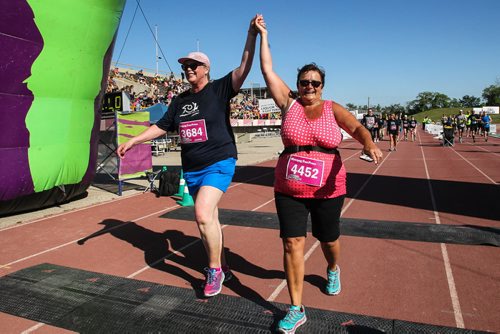 Participants in the Manitoba Marathon approach the finish line inside the University of Manitoba stadium Sunday morning. 150621 - Sunday, June 21, 2015 -  MIKE DEAL / WINNIPEG FREE PRESS