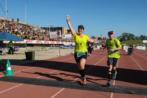 Participants in the Manitoba Marathon approach the finish line inside the University of Manitoba stadium Sunday morning. 150621 - Sunday, June 21, 2015 -  MIKE DEAL / WINNIPEG FREE PRESS