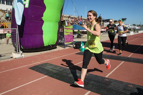 Participants in the Manitoba Marathon approach the finish line inside the University of Manitoba stadium Sunday morning. 150621 - Sunday, June 21, 2015 -  MIKE DEAL / WINNIPEG FREE PRESS