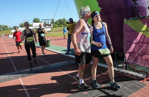 Participants in the Manitoba Marathon approach the finish line inside the University of Manitoba stadium Sunday morning. 150621 - Sunday, June 21, 2015 -  MIKE DEAL / WINNIPEG FREE PRESS