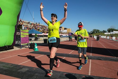 Participants in the Manitoba Marathon approach the finish line inside the University of Manitoba stadium Sunday morning. 150621 - Sunday, June 21, 2015 -  MIKE DEAL / WINNIPEG FREE PRESS