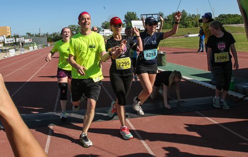 Participants in the Manitoba Marathon approach the finish line inside the University of Manitoba stadium Sunday morning. 150621 - Sunday, June 21, 2015 -  MIKE DEAL / WINNIPEG FREE PRESS