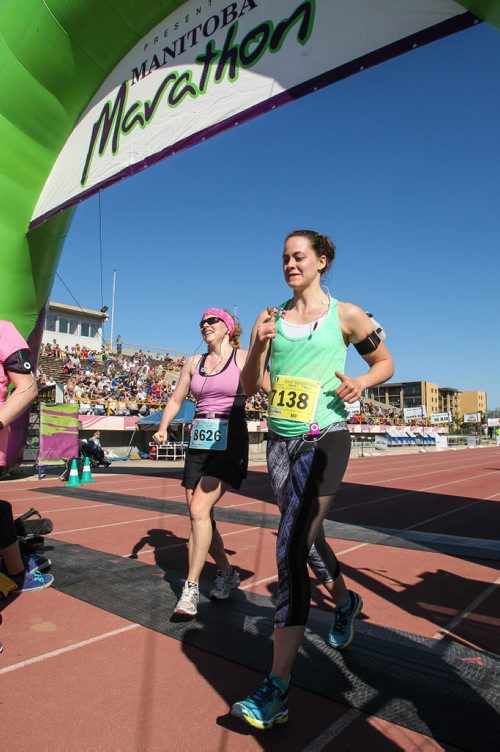 Participants in the Manitoba Marathon approach the finish line inside the University of Manitoba stadium Sunday morning. 150621 - Sunday, June 21, 2015 -  MIKE DEAL / WINNIPEG FREE PRESS