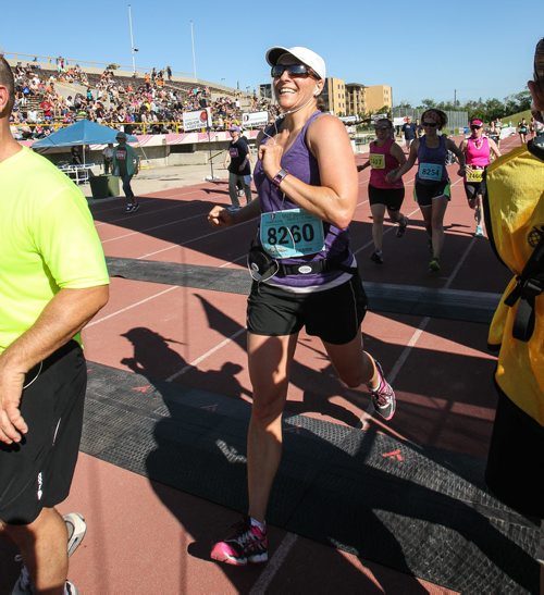 Participants in the Manitoba Marathon approach the finish line inside the University of Manitoba stadium Sunday morning. 150621 - Sunday, June 21, 2015 -  MIKE DEAL / WINNIPEG FREE PRESS