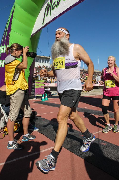 Participants in the Manitoba Marathon approach the finish line inside the University of Manitoba stadium Sunday morning. 150621 - Sunday, June 21, 2015 -  MIKE DEAL / WINNIPEG FREE PRESS