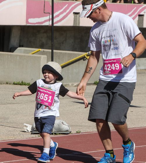 Participants in the Manitoba Marathon approach the finish line inside the University of Manitoba stadium Sunday morning. 150621 - Sunday, June 21, 2015 -  MIKE DEAL / WINNIPEG FREE PRESS