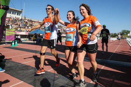 Participants in the Manitoba Marathon approach the finish line inside the University of Manitoba stadium Sunday morning. 150621 - Sunday, June 21, 2015 -  MIKE DEAL / WINNIPEG FREE PRESS