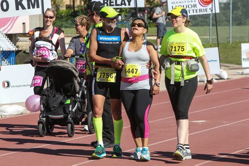 Participants in the Manitoba Marathon approach the finish line inside the University of Manitoba stadium Sunday morning. 150621 - Sunday, June 21, 2015 -  MIKE DEAL / WINNIPEG FREE PRESS