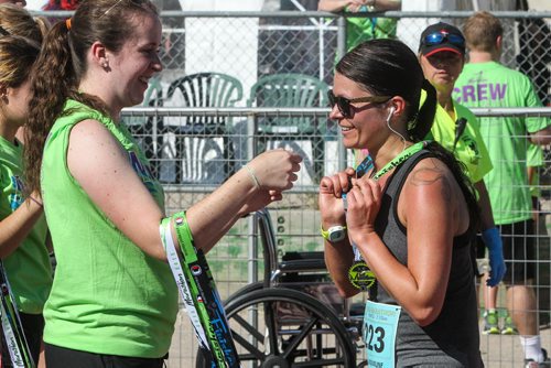 Participants in the Manitoba Marathon approach the finish line inside the University of Manitoba stadium Sunday morning. 150621 - Sunday, June 21, 2015 -  MIKE DEAL / WINNIPEG FREE PRESS