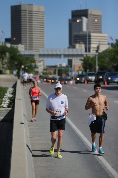 Runners on Main Street. Participants in the Manitoba Marathon, Sunday, June 21, 2015. (TREVOR HAGAN/WINNIPEG FREE PRESS)