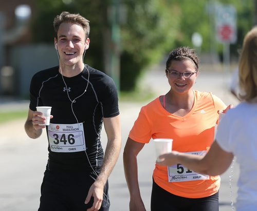 Runners hydrate on Lyndale Drive. Participants in the Manitoba Marathon, Sunday, June 21, 2015. (TREVOR HAGAN/WINNIPEG FREE PRESS)