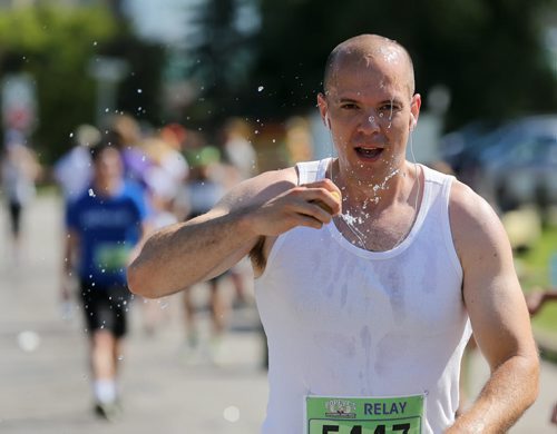 RELAY - bib 5447 - runner 4. A runner hydrates on Lyndale Drive. Participants in the Manitoba Marathon, Sunday, June 21, 2015. (TREVOR HAGAN/WINNIPEG FREE PRESS)