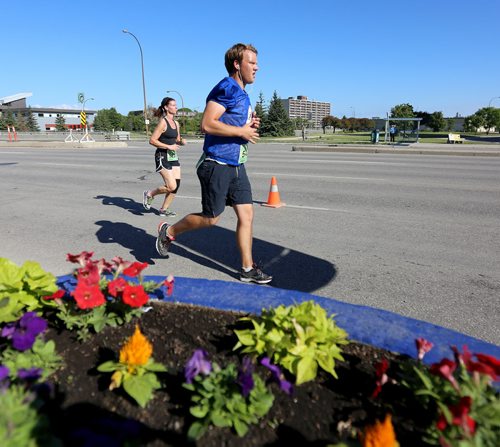 On Portage Avenue near Route 90 overpass. Participants in the Manitoba Marathon, Sunday, June 21, 2015. (TREVOR HAGAN/WINNIPEG FREE PRESS)