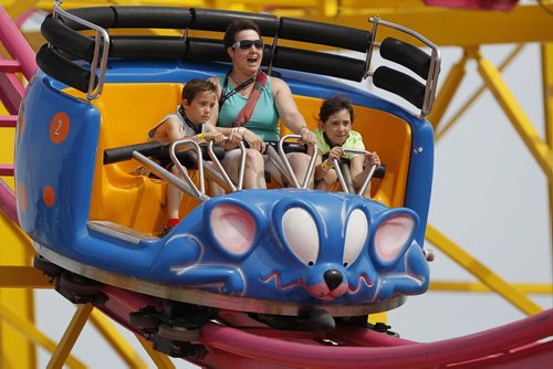 June 21, 2015 - 150621  -  A family goes down Crazy Mouse at the Red River Ex in Winnipeg Sunday, June 21, 2015. John Woods / Winnipeg Free Press