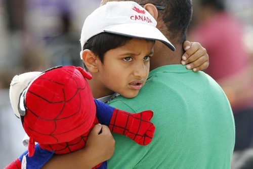 June 21, 2015 - 150621  - Parpap Gaidu takes a break in his dad Kulwanp arms at the Red River Ex in Winnipeg Sunday, June 21, 2015. John Woods / Winnipeg Free Press