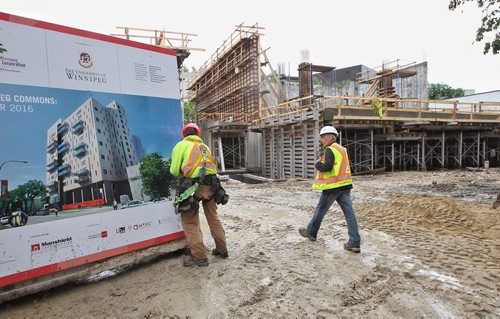 Construction crews get ready for a photo opportunity outside the construction of the new UWinnipeg Commons apartment complex. The 14 story building will house students, families and individuals downtown.  150622 June 22, 2015 MIKE DEAL / WINNIPEG FREE PRESS