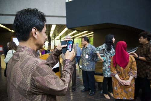 Indonesian inspector Slameto Wiryolukito takes photos  of his fellow Indonesian representatives at a symbolic flag-raising ceremony at the Royal Canadian Mint in Winnipeg on Monday, June 22, 2015.  The mint will now be making coins for Indonesia. Mikaela MacKenzie / Winnipeg Free Press