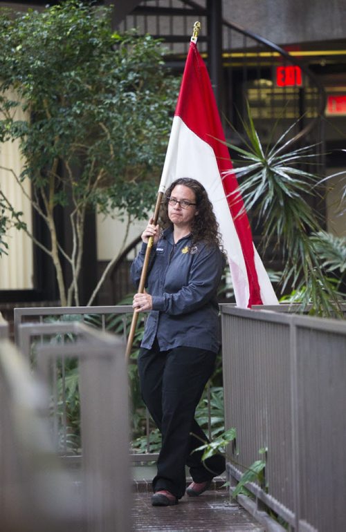 Shannon Laurence carries the flag in at a symbolic flag-raising ceremony at the Royal Canadian Mint in Winnipeg on Monday, June 22, 2015.  The mint will now be making coins for Indonesia. Mikaela MacKenzie / Winnipeg Free Press