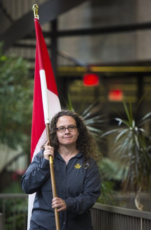 Shannon Laurence carries the flag in at a symbolic flag-raising ceremony at the Royal Canadian Mint in Winnipeg on Monday, June 22, 2015.  The mint will now be making coins for Indonesia. Mikaela MacKenzie / Winnipeg Free Press
