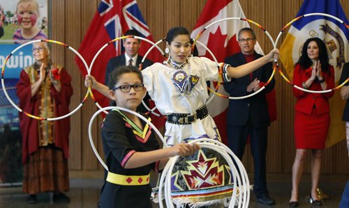 Hoop dancers Shanley Spence and Danielle Sinclair, in the foreground performed at City Hall Monday at Mayor Brian Bowman's announcement of the members on the Mayors Indigenous Advisory Circle to advise on policies the City of Winnipeg can implement to continue to build awareness, bridges and understanding between the Aboriginal and non-Aboriginal community. In back from left is Mae Louise Campbell, Mayor Brian Bowman, Damon Johnston  and Kimberley Puhach.  Aldo Santin story. Wayne Glowacki / Winnipeg Free Press June 22  2015