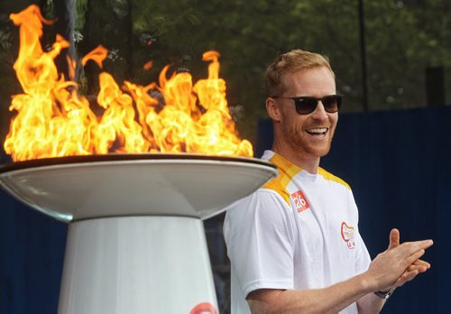 Olympian Jon Montgomery claps after lighting the cauldron during a Torch Relay ceremony Monday afternoon at The Forks.  150622 June 22, 2015 MIKE DEAL / WINNIPEG FREE PRESS