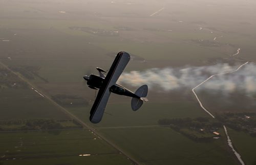 Pilot Luke Penner turns on smoke as he rolls the Pitts S2B aerobatic biplane over Steinbach. Harv's Air Pilot Training offers rides in the Pitts S2B aerobatic biplane for $250 a demonstration ride. The trip can include loops, rolls, hammerheads, barrel rolls and vertical rolls among other aerobatic maneuvers.  June 11, 2015 - MELISSA TAIT / WINNIPEG FREE PRESS