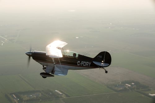 Pilot Luke Penner aboard the Pitts S2B aerobatic biplane over Steinbach. Harv's Air Pilot Training offers rides in the Pitts S2B aerobatic biplane for $250 a demonstration ride. The trip can include loops, rolls, hammerheads, barrel rolls and vertical rolls among other aerobatic maneuvers.  June 11, 2015 - MELISSA TAIT / WINNIPEG FREE PRESS