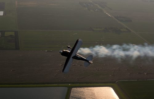 Pilot Luke Penner turns on smoke as he rolls the Pitts S2B aerobatic biplane over Steinbach. Harv's Air Pilot Training offers rides in the Pitts S2B aerobatic biplane for $250 a demonstration ride. The trip can include loops, rolls, hammerheads, barrel rolls and vertical rolls among other aerobatic maneuvers.  June 11, 2015 - MELISSA TAIT / WINNIPEG FREE PRESS